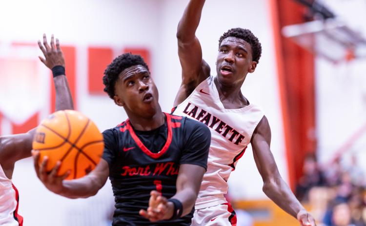 Fort White guard Jayden Jackson drives for a shot as Lafayette guard Jordan Murphy defends Thursday night. Jackson scored 24 points to lead the Indians to a 61-33 win. (JACK HOWDESHELL/Lake City Reporter)