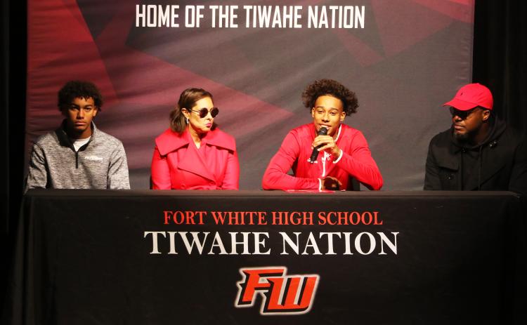 Fort White receiver Mike Peterson Jr. (middle left) speaks during his signing ceremony Wednesday alongside his brother, Gavin (left) mother, Chantal (middle right), and his father, Mike (right). Peterson signed his letter of intent to play collegiately at Arkansas State. (MORGAN MCMULLEN/Lake City Reporter)
