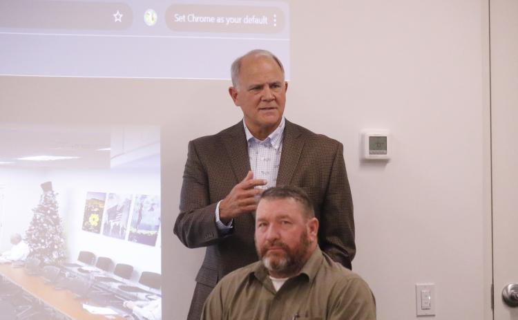 Former State Rep. Bobby Payne (top) speaks during the NFWUA meeting Wednesday in front of Leo Mobley, a board member. (JAMIE WACHTER/Lake City Reporter)