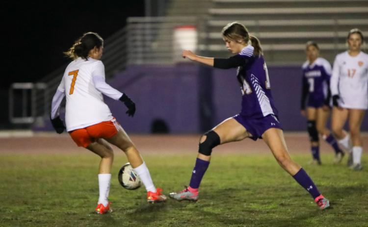 Columbia's Mia Brasel tries to dribble past Orange Park's Heily Davila on Jan. 9. (BRENT KUYKENDALL/Lake City Reporter)