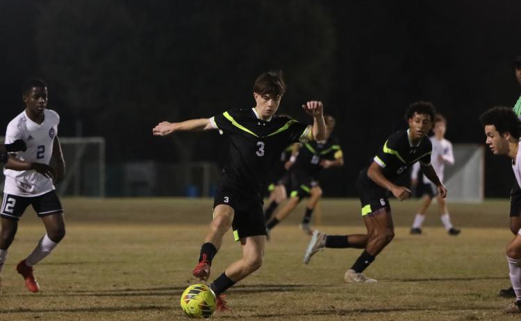 Columbia's Cody Bass dribbles the ball up the field against Gainesville on Jan. 10. (BRENT KUYKENDALL/Lake City Reporter)