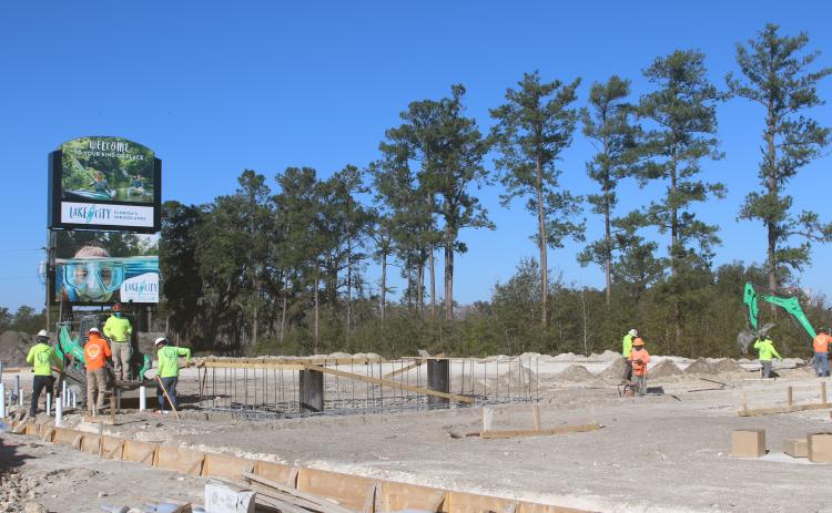 A crew works on the U-Haul storage facility site in the Gateway Crossing development Friday at the Interstate 75 and U.S. Highway 90 interchange. (TONY BRITT/Lake City Reporter)