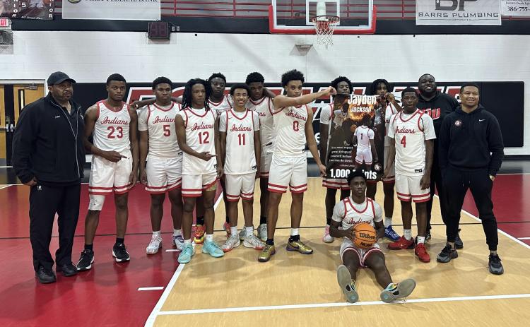 Fort White’s boys basketball team celebrates Jaydan Jackson’s 1,000th career point following Thursday’s win over Bronson. (COURTESY)