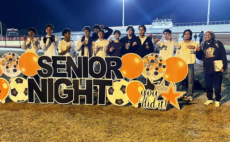 Columbia’s boys soccer team poses with Orange Park’s Senior Night sign after defeating the Raiders 2-0 on Friday. (COURTESY)