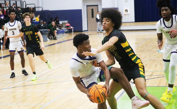 Columbia guard Murkail Cray is fouled by Forest forward Trey Chisolm during the Hitchcock's Challenge championship on Dec. 29. (JORDAN KROEGER/Lake City Reporter)