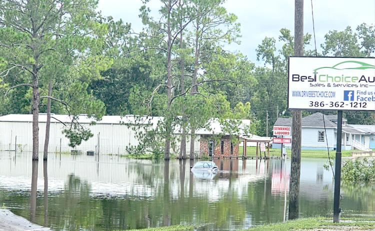 A car sits submerged in flood waters on Ohio Avenue (U.S. Highway 129) in Live Oak following Hurricane Debby in August. (FILE)
