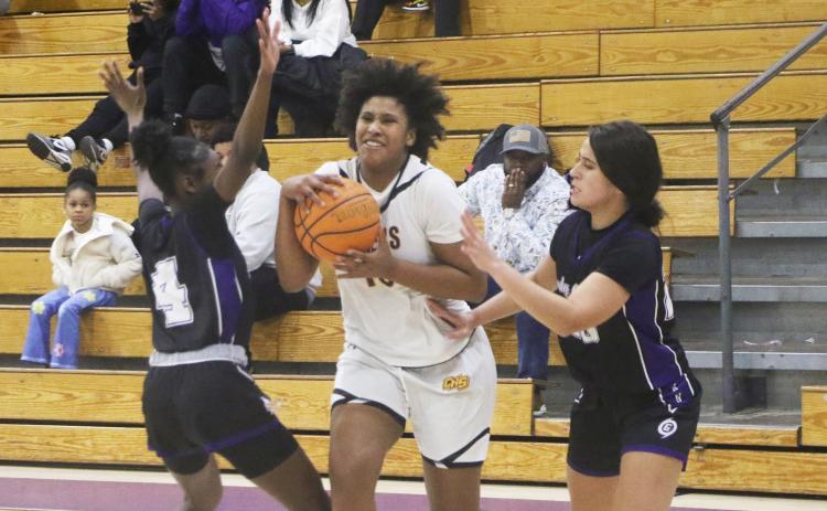 Columbia forward Jolena Gardner tries to split a pair of Gainesville defenders Friday night. (MORGAN MCMULLEN/Lake City Reporter)
