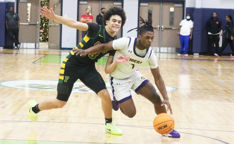 Columbia guard Zamarion Jones dribbles past Forest guard Elijah Leon during the Hitchcock’s Challenge championship on Dec. 29 at Legacy Park in Alachua. (JORDAN KROEGER/Lake City Reporter)