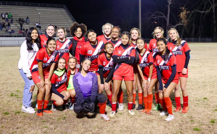 The Lafayette girls soccer team poses with the District 2-2A championship trophy after defeating Branford 1-0 on Tuesday night. (JACK HOWDESHELL/Lake City Reporter)