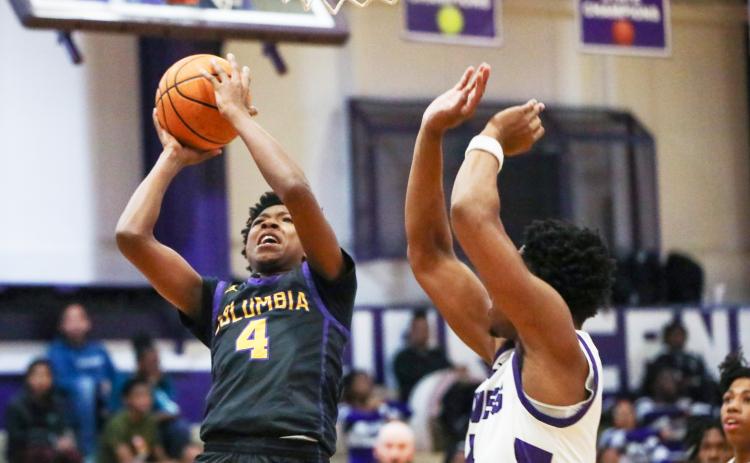 Columbia guard Shaheed White shoots while defended by Gainesville forward Cornelius White on Jan. 23. (BRENT KUYKENDALL/Lake City Reporter)