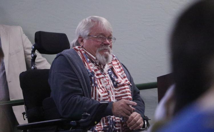 Jeff Woods, a disabled veteran, pleads through tears with Sen. Jennifer Bradley and Rep. Chuck Brannan to provide help with the misuse of handicapped parking spaces. (JAMIE WACHTER/Lake City Reporter)