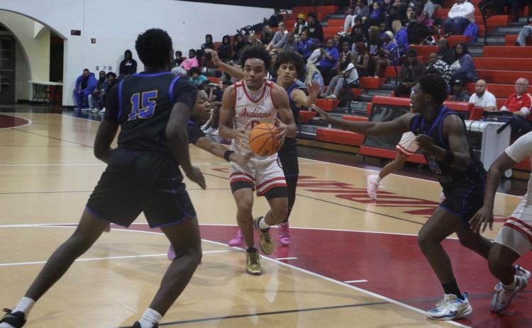 Fort White guard Tafari Moe gets surrounded by four Newberry defenders on his way to the rim in Thursday’s loss. (MORGAN MCMULLEN/Lake City Reporter)