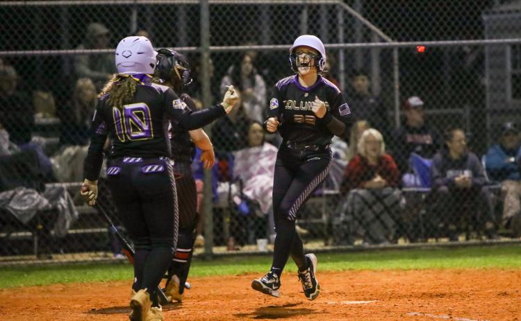 Columbia catcher Emily Delgado celebrates as she scores to tie the game in the fifth inning of Monday's season opener against Fort White. (BRENT KUYKENDALL/Lake City Reporter)