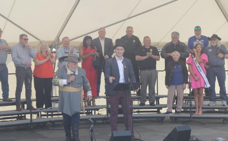 Lake City Mayor Noah Walker (right) gives a speech next to Tony Buzzella to open the 46th annual Olustee Festival. (TONY BRITT/Lake City Reporter)