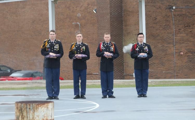 Four Columbia High School JROTC Cadets hold old flags set to be destroyed during the JROTC’s Flag Retirement Service on Thursday morning. (TONY BRITT/Lake City Reporter)