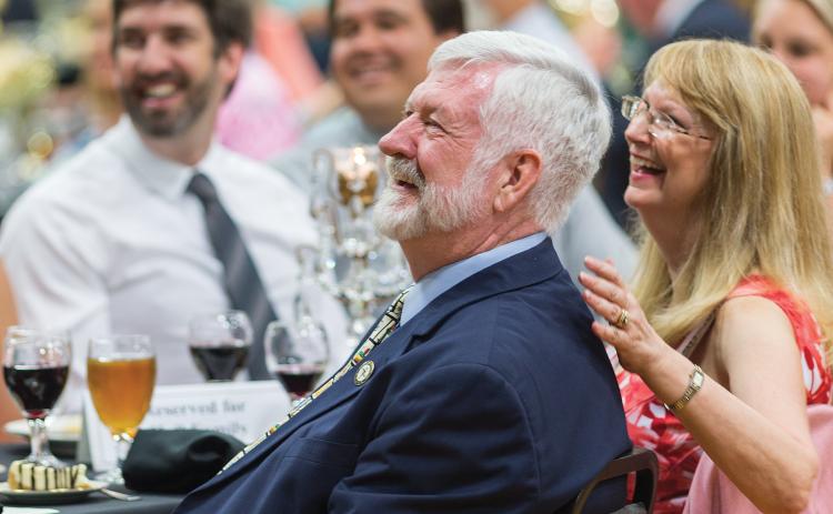 Dr. Charles Hall laughs during his retirement celebration at Florida Gateway College in 2015. Hall, accompanied by his wife, Robin, had served as the college president for 18 years. (FILE)
