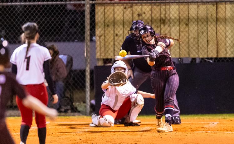 Fort White pitcher Hannah LeBleu knocks a base hit against Dixie County on Thursday. (JACK HOWDESHELL/Lake City Reporter)