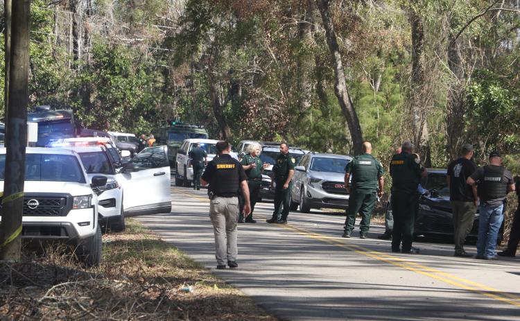 Columbia County Sheriff’s Office deputies arrive at the scene on SW Washington Avenue in Fort White in response to an officer-involved shooting Wednesday morning. (MORGAN MCMULLEN/Lake City Reporter)