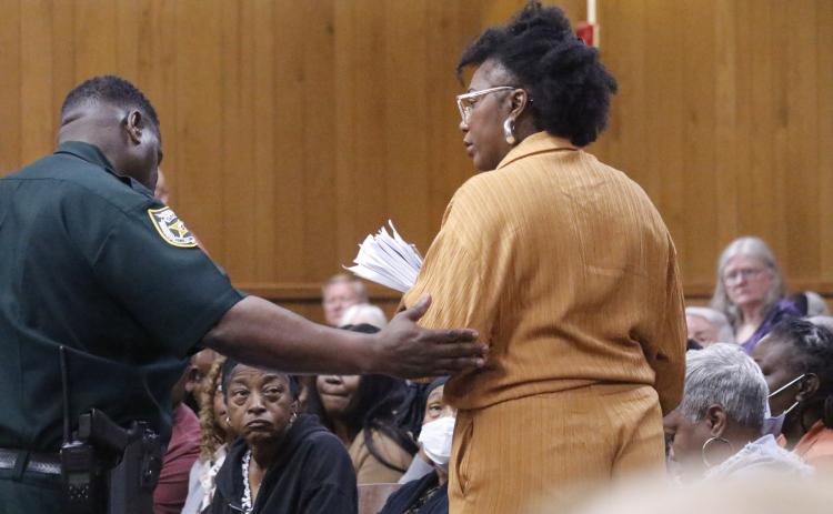 White Springs Town Manager Vanessa George is escorted out of the Hamilton County Courthouse courtoom Monday during the county’s legislative delegation hearing. George was removed after repeatedly interrupting Sen. Corey Simon. (JAMIE WACHTER/Lake City Reporter)