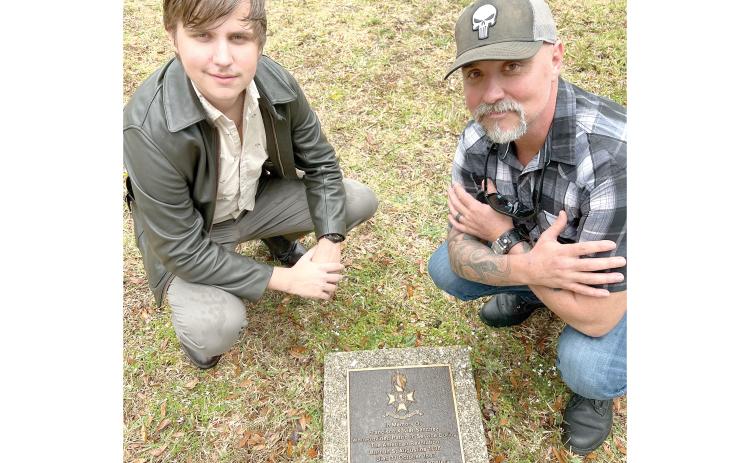 Todd Denmark (right) and his son, Jackson, visit their ancestor’s grave in St. Augustine as part of a trip to connect with their family’s history. (COURTESY)