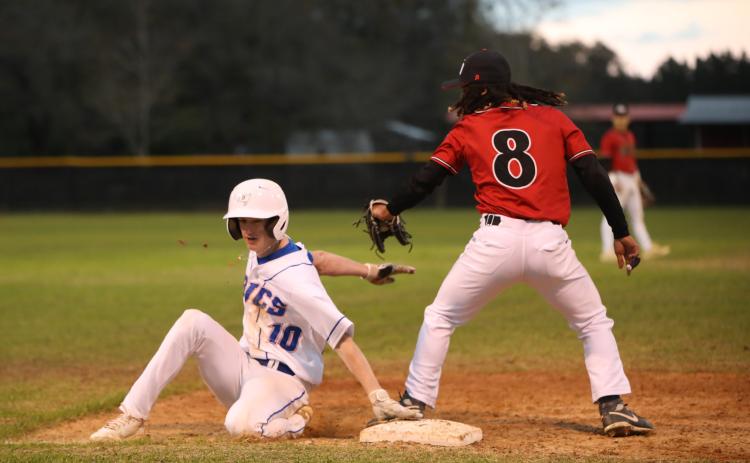 Branford's Patrick Williams slides safely into third base against Fort White on March 10. (BRENT KUYKENDALL/Lake City Reporter)