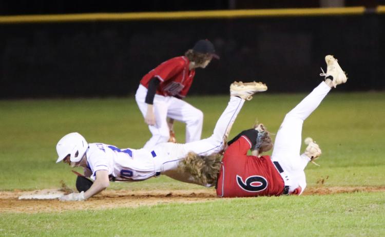 Branford shortstop Patrick Williams collides with Fort White shortstop Matthew Pitts as he tries to dive into second base Monday night. Pitts was called for obstruction and Williams was awarded an extra base. (BRENT KUYKENDALL/Lake City Reporter)