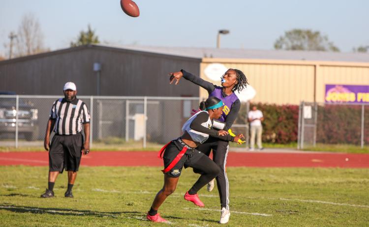 Columbia quarterback Eriel Baker throws a pass under pressure from a Buchholz defender on Tuesday night. (BRENT KUYKENDALL/Lake City Reporter)
