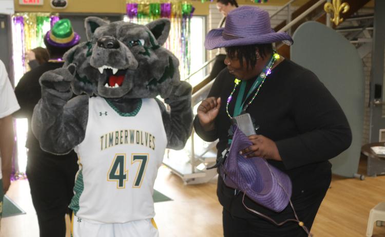 Bolts, the Florida Gateway College mascot, and Shawana Wilson dance to Zydeco music in the college’s student center on Tuesday during a Mardi Gras celebration. (TONY BRITT/Lake City Reporter)