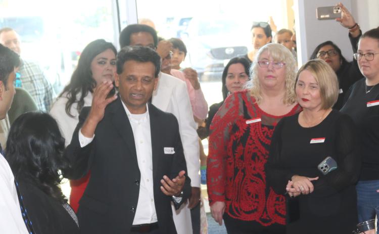Nick Patel (left), Lake City Hotels Chief Operating Officer, the management company and owner of TownePlace Suites by Marriott, addresses the audience during Tuesday afternoon’s grand opening ceremony for the hotel. (TONY BRITT/Lake City Reporter)