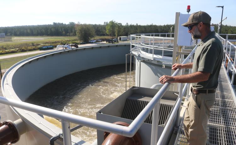 City of Lake City Wastewater Director Cody Pridgeon looks in on a tank of untreated wastewater Wednesday morning at the North Florida Mega Industrial Park wastewater plant, which recently started operations. (TONY BRITT/Lake City Reporter)
