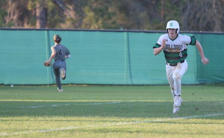 Suwannee first baseman Kyler Watson races home to score a run against Chiles on March 11. (PAUL BUCHANAN/Lake City Reporter)