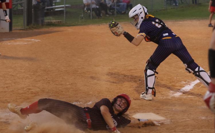 Williston’s Brooklyn Bertrand slides safely into home plate ahead of the tag from Columbia catcher Emily Delgado in the Tigers’ 11-0 loss Tuesday. (MORGAN MCMULLEN/Lake City Reporter)