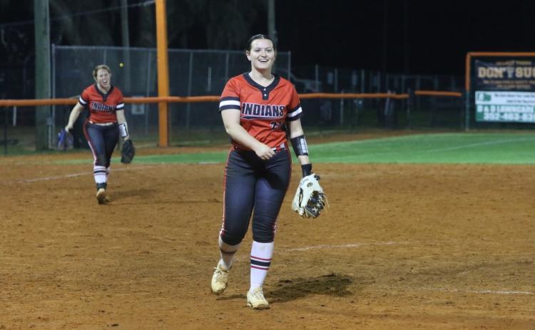Fort White pitcher Kadence Compton is all smiles after striking out the final batter in Monday’s 7-5 win over Trenton as third baseman Hannah LeBleu cheers her on. (MORGAN MCMULLEN/Lake City Reporter)