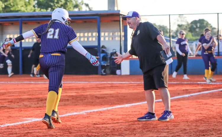 Columbia pitcher Harleigh Price high fives coach Joe Saucier as she rounds third base after hitting a home run against Branford on Tuesday. (BRENT KUYKENDALL/Lake City Reporter)