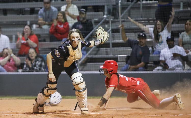 Middleburg third baseman KK Hagan slides under the tag of Columbia catcher Emily Delgado to score the go-ahead run in the seventh inning Thursday. The Broncos scored five runs in the inning to win 8-3. (BRENT KUYKENDALL/Lake City Reporter)
