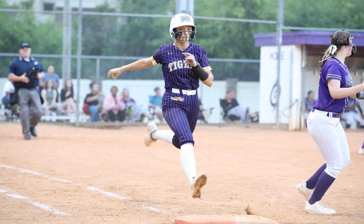 Columbia catcher Emily Delgado is thrown out at first base during Tuesday's loss to Gainesville. (BRENT KUYKENDALL/Lake City Reporter)