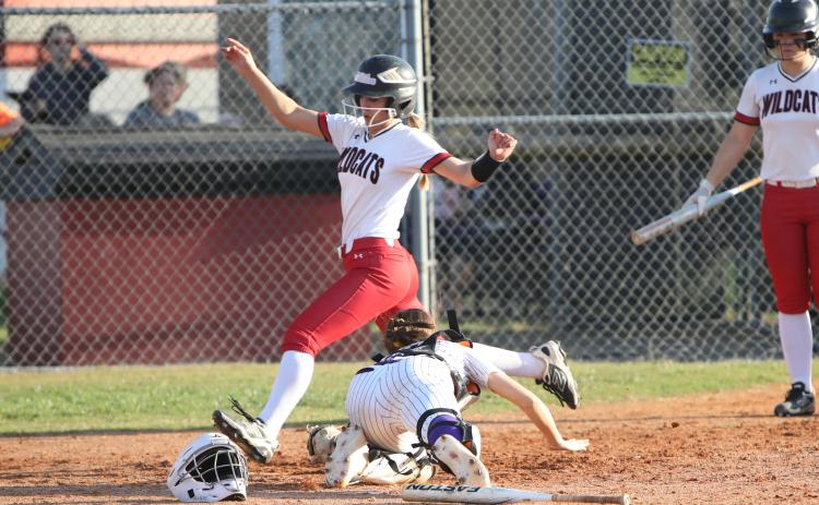 Columbia catcher Emily Delgado's tag isn't in time to stop one of Baker County's 10 runs on Thursday. (BRENT KUYKENDALL/Lake City Reporter)