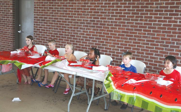 Quinny Shepple (from left), Cooper Shepple, Kahlani Kelley, Farrah Combs, Levi Powell and Ava Brown get ready to down some watermelon during the kids’ watermelon eating contest at the Rotary Club of Lake City’s downtown Independence Day event last year. (FILE)