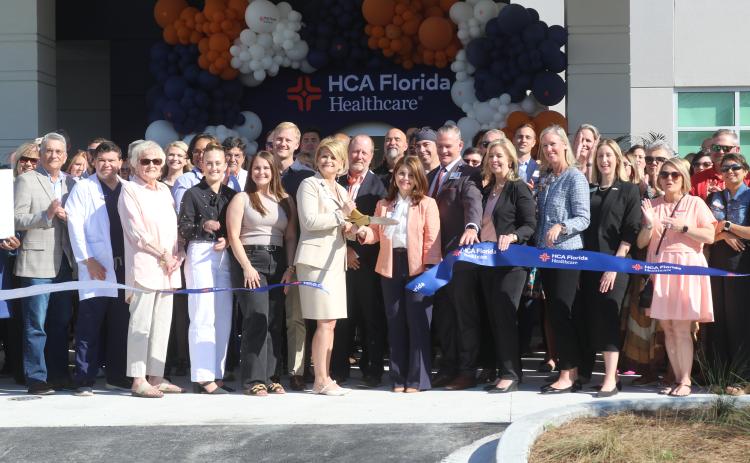 A crowd of well wishers, community supporters and local officials celebrate the ribbon cutting for the HCA Lake City Hospital’s expansion opening with board, administration and staff members on Tuesday. (TONY BRITT/Lake City Reporter)