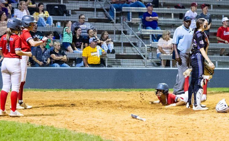Santa Fe left fielder Madison Crosby slides safely into home plate to score a run against Columbia on Tuesday. (JACK HOWDESHELL/Lake City Reporter)