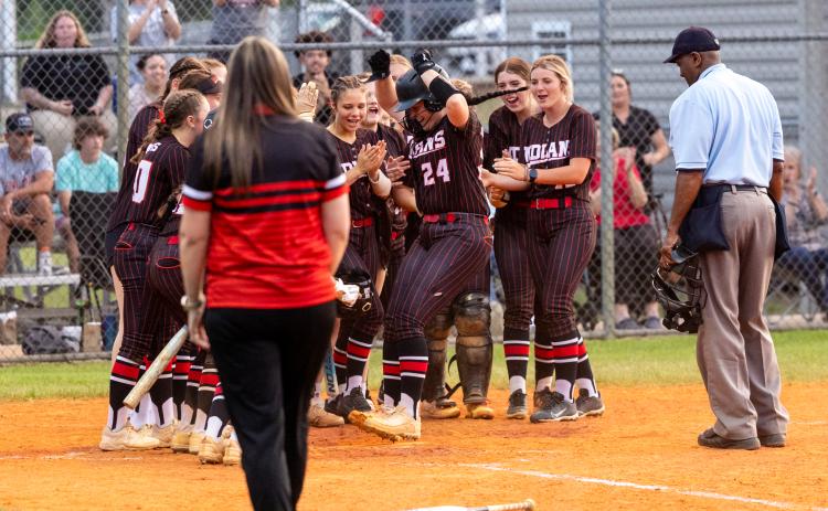 Fort White pitcher Kadence Compton celebrates at home plate with her teammates after hitting a two-run home run during Tuesday's 3-1 win over Suwannee. (JACK HOWDESHELL/Lake City Reporter)