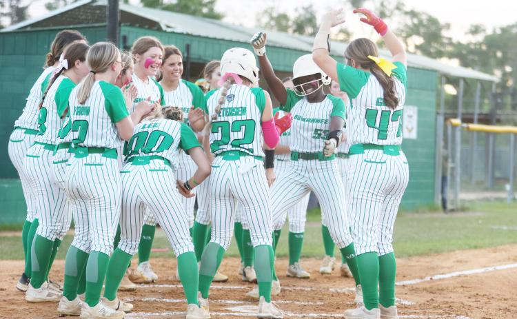 Suwannee outfielder Brianna Woods celebrates at home plate with her teammates after hitting a solo home run against Fort White on Friday. (PAUL BUCHANAN/Lake City Reporter)