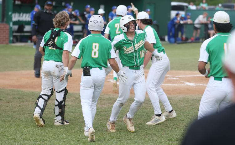 Suwannee's Hampton Newman (16) celebrates with teammates after scoring a run against Wolfson in the District 3-3A semifinals on Tuesday. (PAUL BUCHANAN/Lake City Reporter)