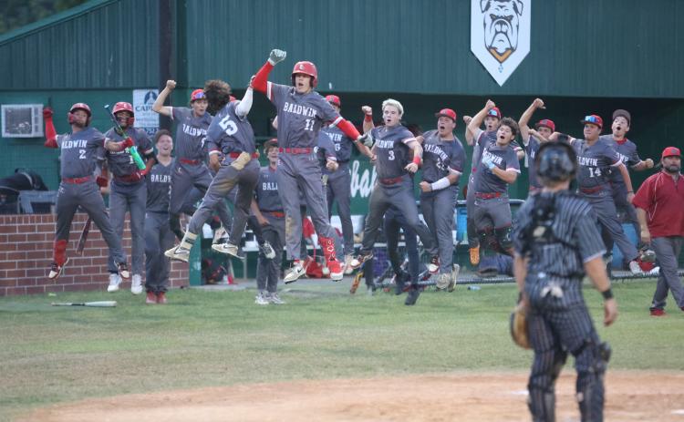 Baldwin's Turner Farah celebrates with teammates after hitting a home run while Suwannee catcher Grayson Bonds looks on during Game 2 of the Region 1-3A quarterfinals on Tuesday. (PAUL BUCHANAN/Lake City Reporter)