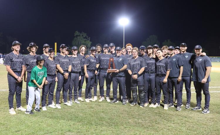 Suwannee's baseball team poses with the District 3-3A trophy after defeating Paxon 10-0 on Thursday. (PAUL BUCHANAN/Lake City Reporter)