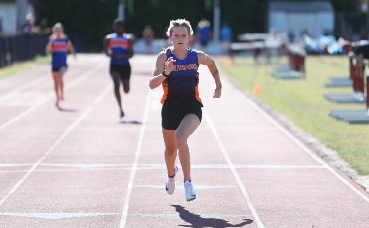 Branford runner Alex Whitfield races to the finish line to win the 100m title at the District 5-1A meet on Saturday. (PAUL BUCHANAN/Lake City Reporter)