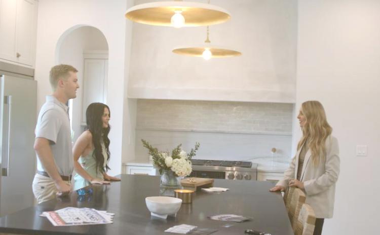 Rylee and Adrianna McKenzie talk with Noelle Royster (right), who was helping to show the home near Lake Jeffery for IC Construction during the 2024 Parade of Homes. (FILE)