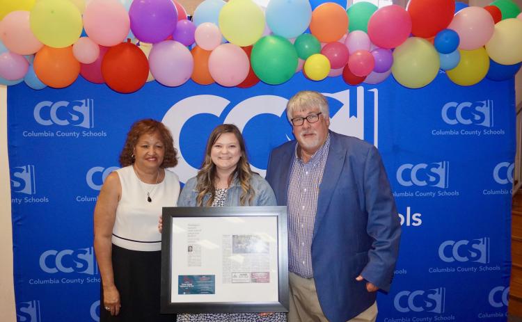 Summers Elementary VPK paraprofessional Kelsie Rodriguez (center) was honored by Columbia School Board member Narrie Smith (left) and Superintendent Keith Couey during Tuesday’s school board meeting. (COURTESY)