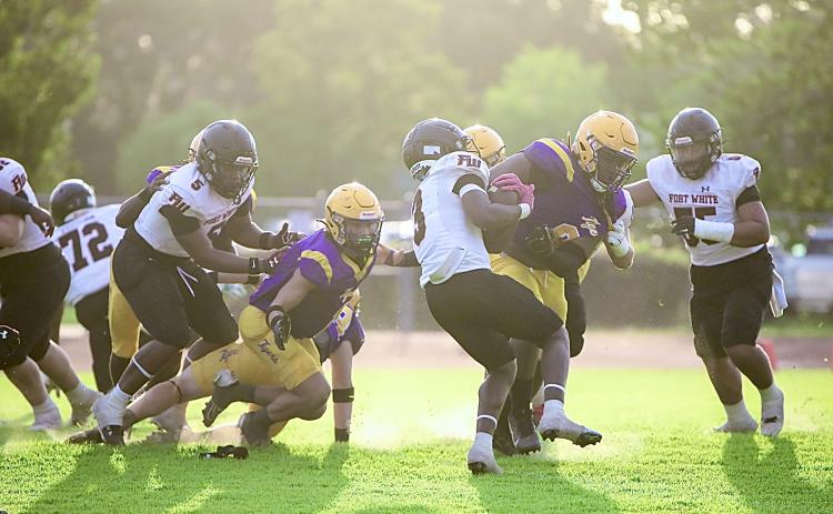 Columbia defensive tackle Jaylen Underwood (8) delivers a hit to Fort White running back Elijah Gardner during the teams’ spring game on May 17. (BRENT KUYKENDALL/Lake City Reporter)