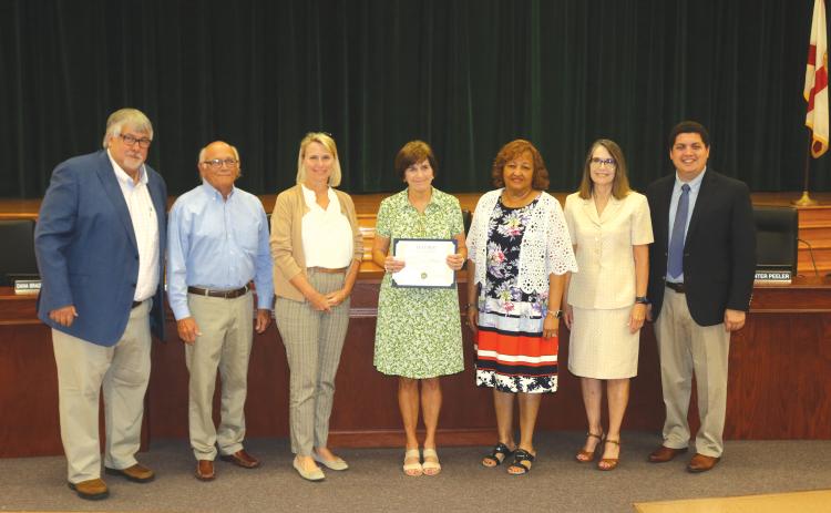 Sara Lou Blanton (center), along with John Brown, Linda Moses and Arthur ‘Art’ Holliday, were honored at Tuesday’s Teacher of a Lifetime ceremony at the Keith Hudson School Board Auditorium. (TONY BRITT/Lake City Reporter)
